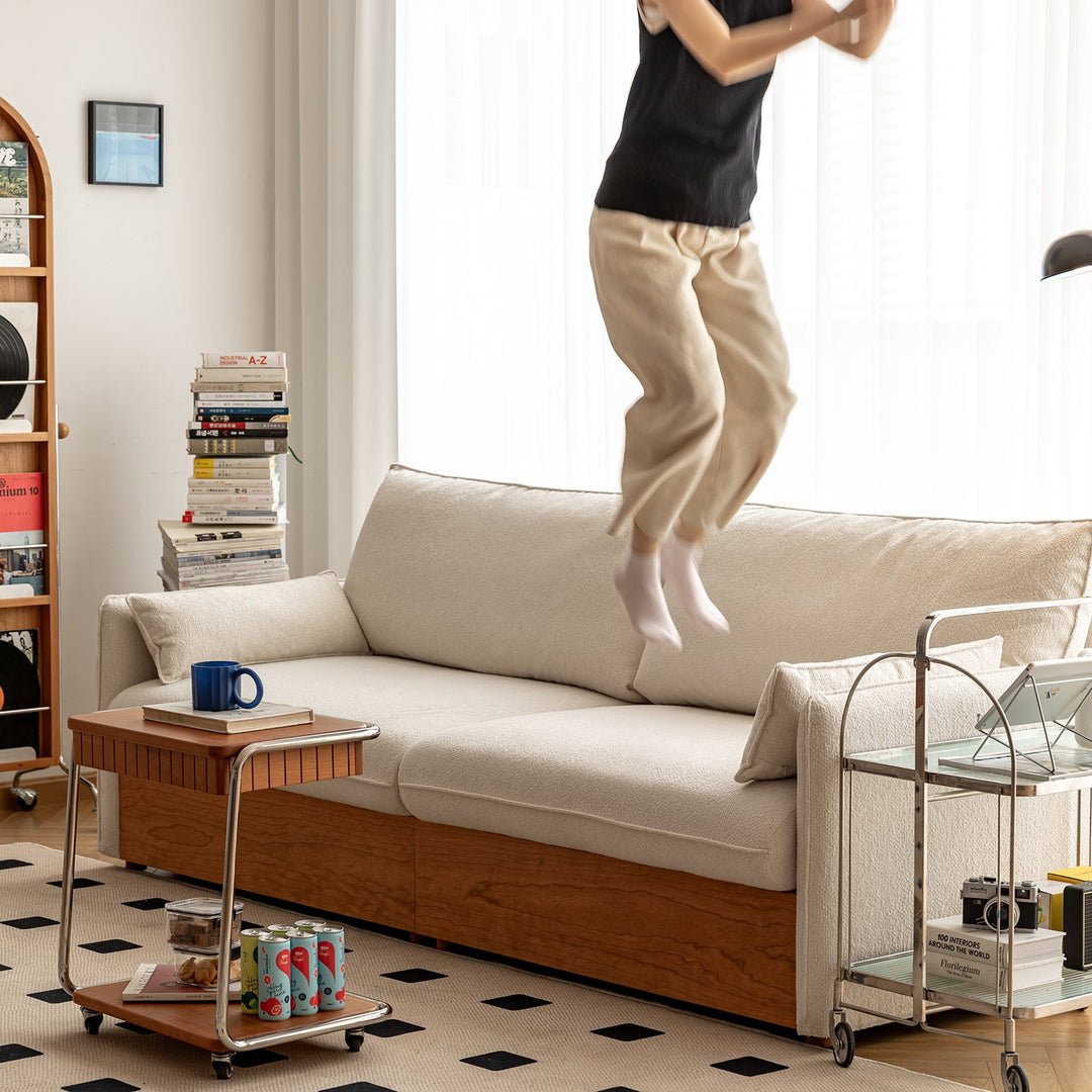 Modern 2-seater boucle fabric sofa with built-in storage, styled in a minimalist living room, available ready in stock for fast delivery.