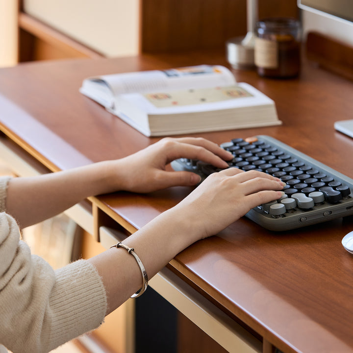 Vintage boxwood electric height adjustable lift-up study table elevate in close up details.